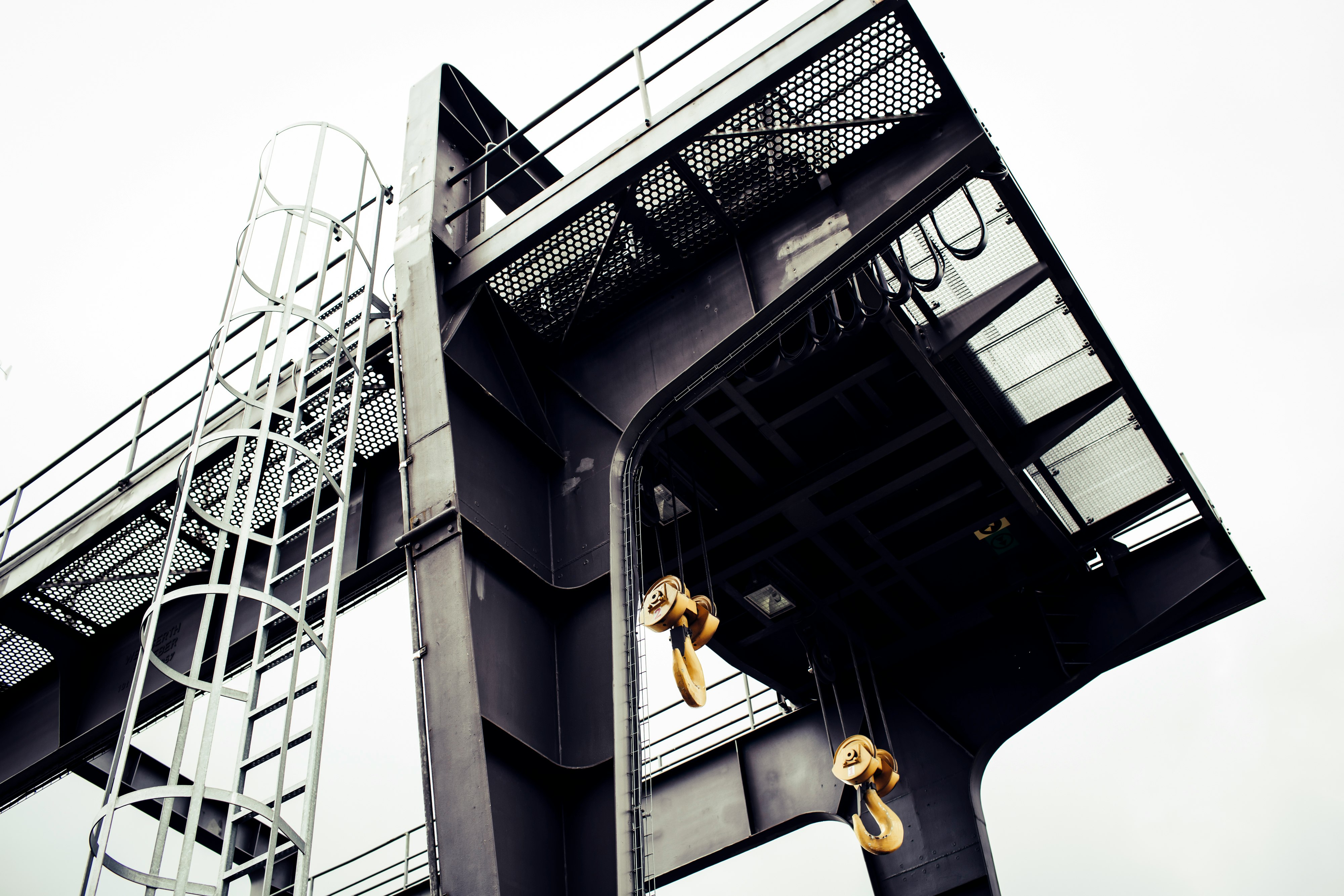 man in yellow shirt and black pants jumping on black building